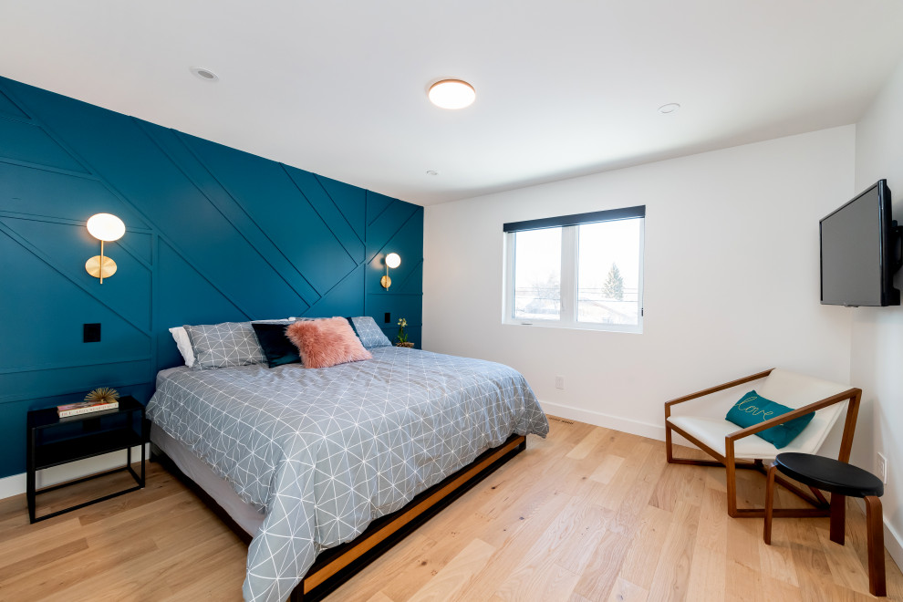 Bedroom - mid-sized contemporary master light wood floor and brown floor bedroom idea with blue walls and no fireplace