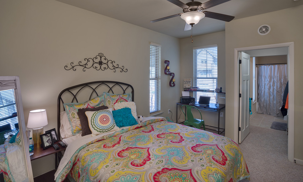 Mid-sized country guest bedroom in Charlotte with beige walls, carpet and beige floor.
