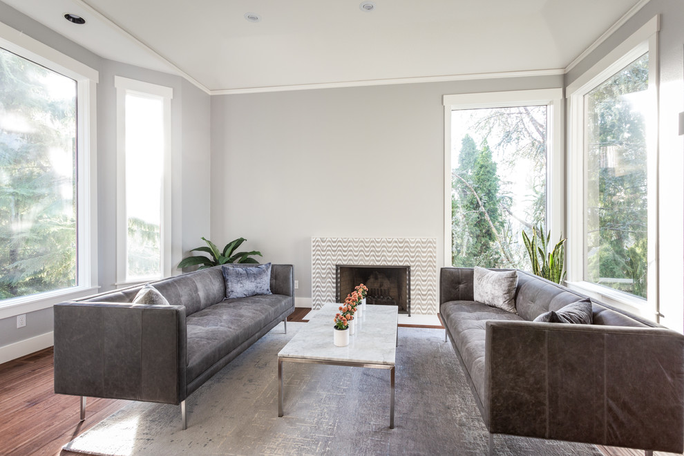 Large formal open concept living room in Portland with grey walls, medium hardwood floors, a standard fireplace, a brick fireplace surround and brown floor.