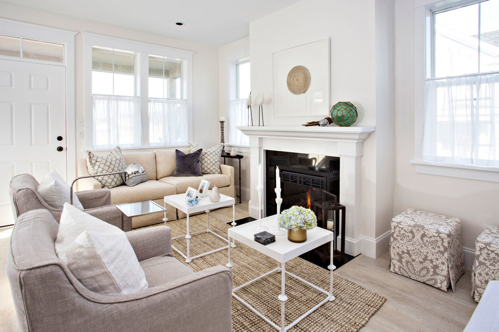 Transitional living room in Boston with white walls and a standard fireplace.