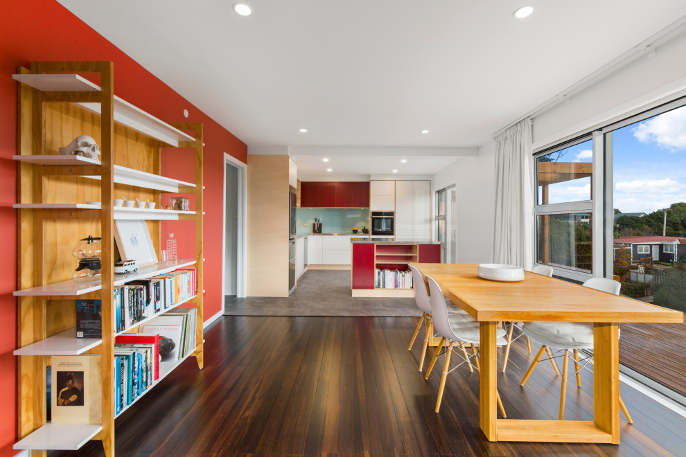 Mid-sized contemporary dining room in Wollongong with orange walls, dark hardwood floors and brown floor.