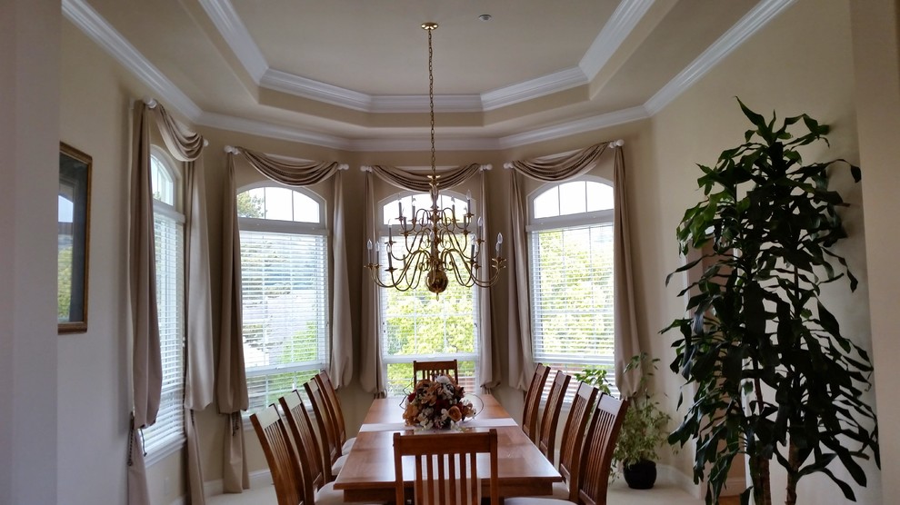 This is an example of a mid-sized traditional separate dining room in San Francisco with beige walls, ceramic floors, no fireplace and white floor.