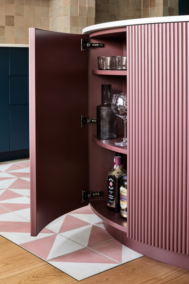 Inspiration for a contemporary home bar in London with beaded inset cabinets.