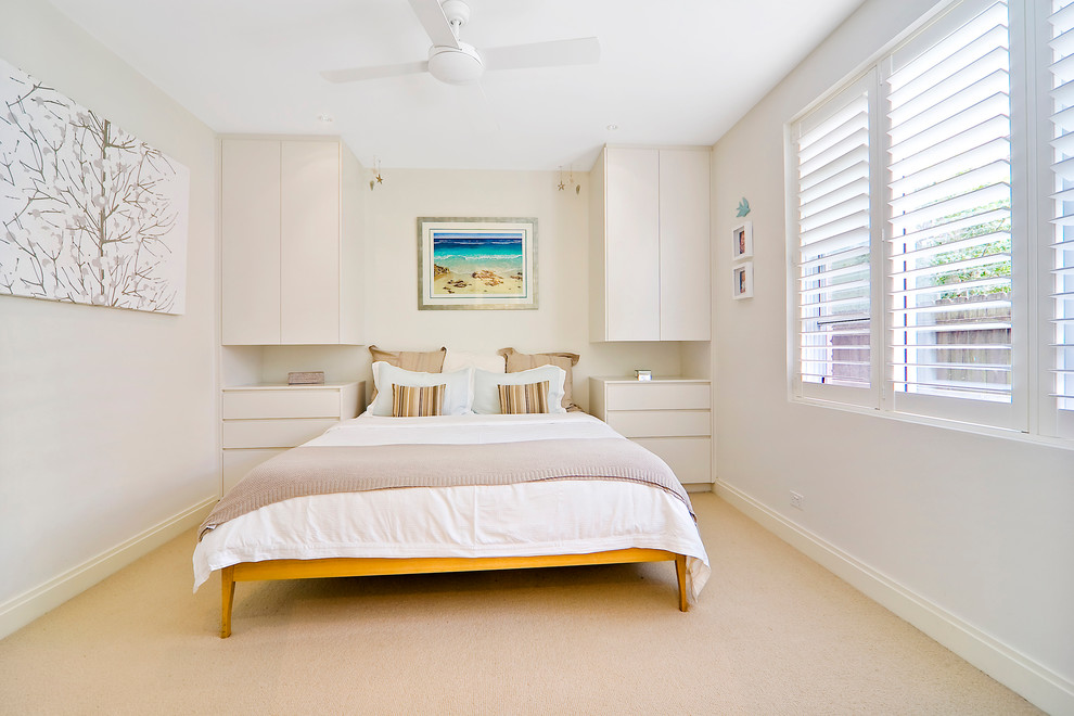 Contemporary bedroom in Sydney with beige walls and carpet.