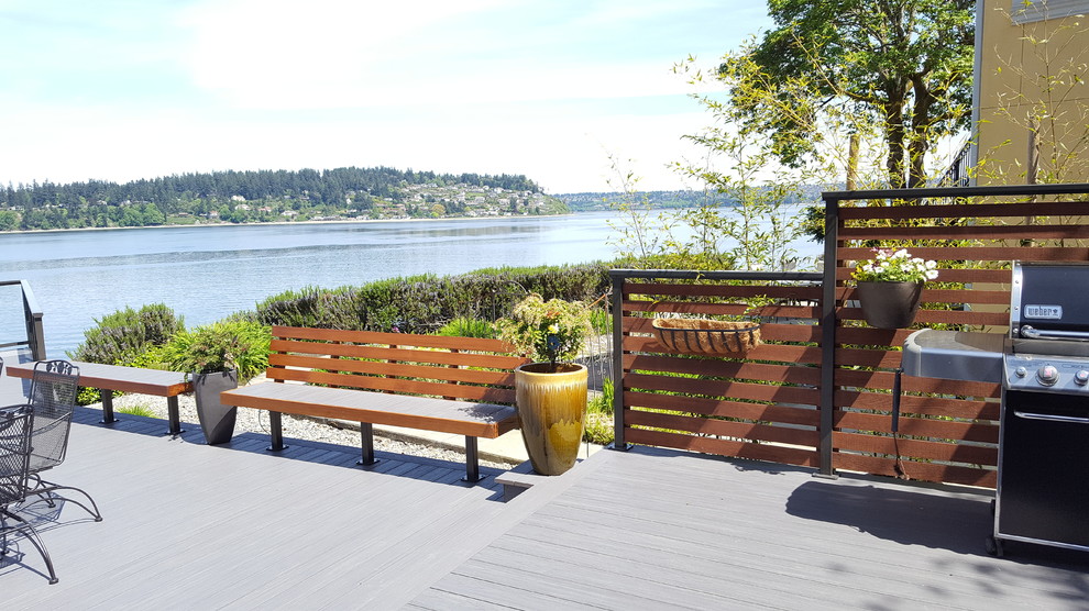 Photo of a mid-sized beach style backyard deck in Seattle with no cover.