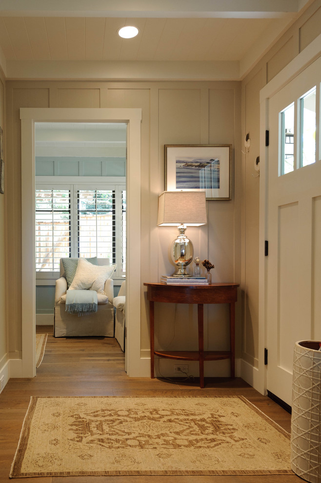 Inspiration for a beach style entryway in San Francisco with beige walls, a single front door, a white front door and medium hardwood floors.