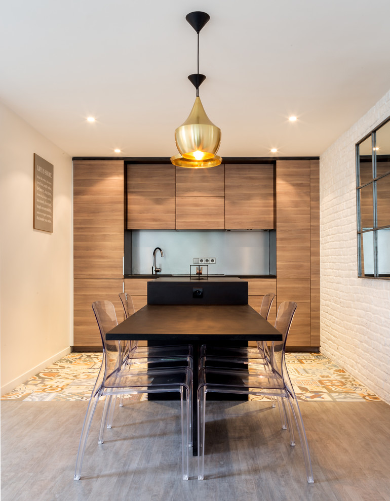 Large contemporary single-wall open plan kitchen in Paris with medium wood cabinets, an undermount sink, beaded inset cabinets, wood benchtops, grey splashback, cement tiles, with island and black benchtop.