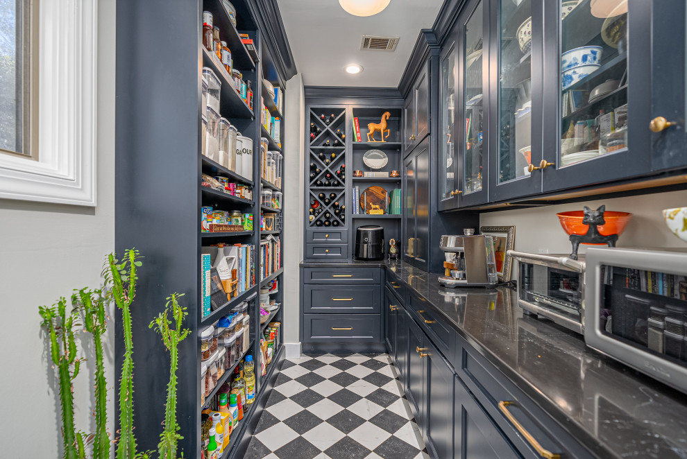 Kitchen pantry - transitional u-shaped multicolored floor kitchen pantry idea in Atlanta with recessed-panel cabinets, blue cabinets, no island and black countertops