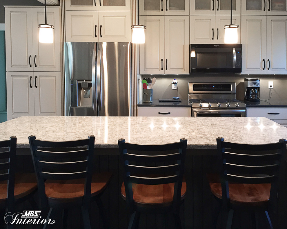 Example of a transitional l-shaped kitchen design with a farmhouse sink, white cabinets, quartz countertops, stainless steel appliances and an island