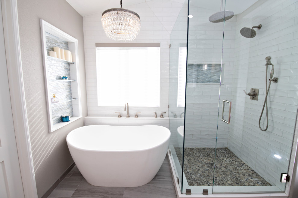 Design ideas for a medium sized modern ensuite bathroom in San Diego with shaker cabinets, a freestanding bath, a corner shower, a two-piece toilet, blue tiles, ceramic tiles, grey walls, a submerged sink, engineered stone worktops, a hinged door, white worktops, a wall niche, a built in vanity unit and a vaulted ceiling.