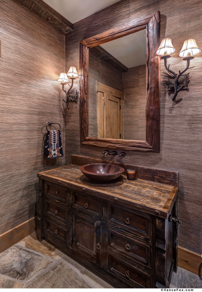 Photo of a small contemporary powder room in Other with brown walls, slate floors, a vessel sink, wood benchtops, brown floor, brown benchtops, a freestanding vanity, wood and wallpaper.