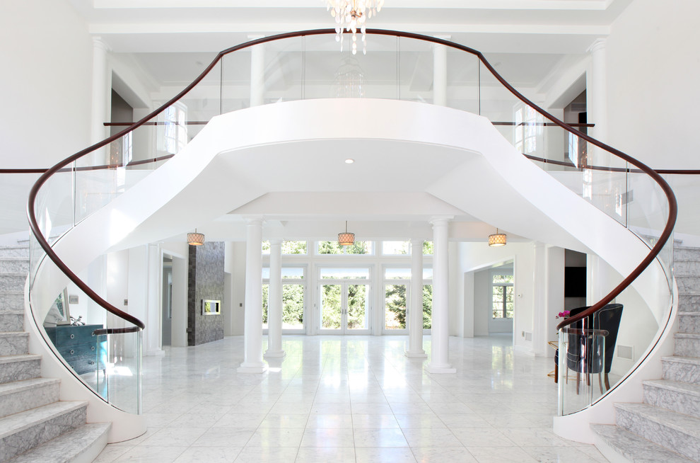 Expansive contemporary marble floating staircase in Other with marble risers and glass railing.