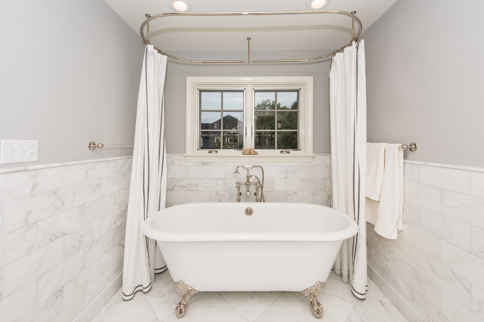Design ideas for a large transitional master bathroom in DC Metro with a claw-foot tub, an alcove shower, gray tile, stone tile, blue walls and marble floors.