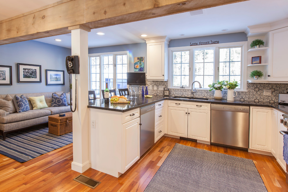 Eat-in kitchen - large transitional l-shaped light wood floor eat-in kitchen idea in Boston with an undermount sink, shaker cabinets, white cabinets, granite countertops, blue backsplash, cement tile backsplash, stainless steel appliances and an island