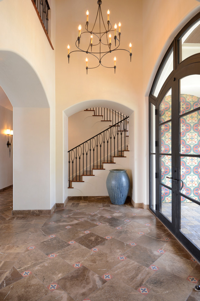 This is an example of a large transitional front door in Austin with white walls, marble floors, a double front door and a dark wood front door.
