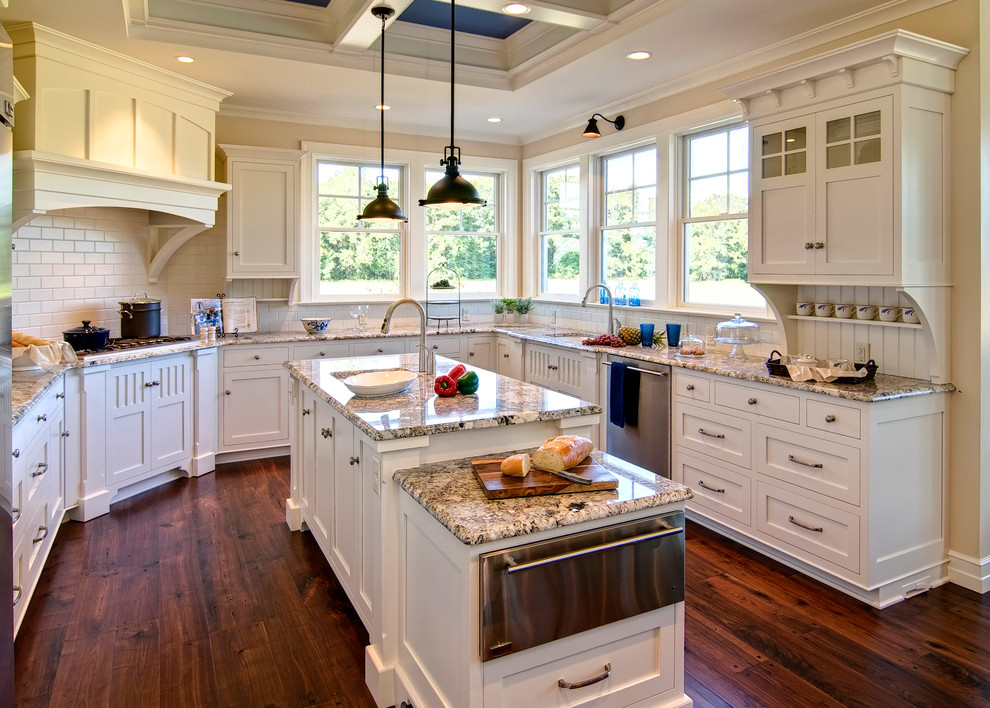 Transitional u-shaped medium tone wood floor and brown floor kitchen photo in Chicago with an undermount sink, shaker cabinets, white cabinets, white backsplash, subway tile backsplash, stainless steel appliances, an island and brown countertops