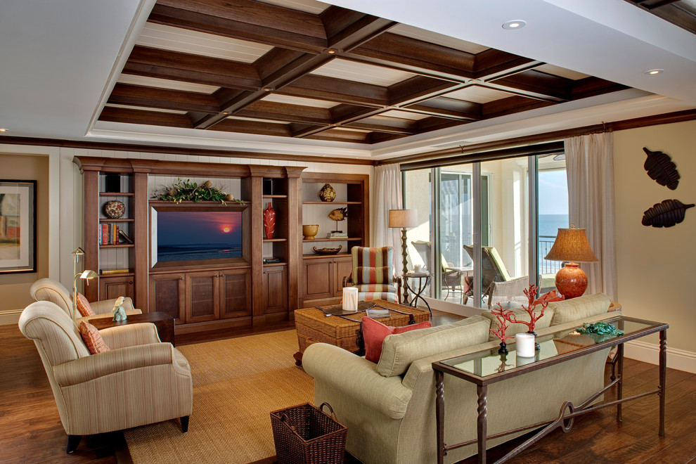 This is an example of a mid-sized tropical open concept family room in Miami with beige walls and a built-in media wall.