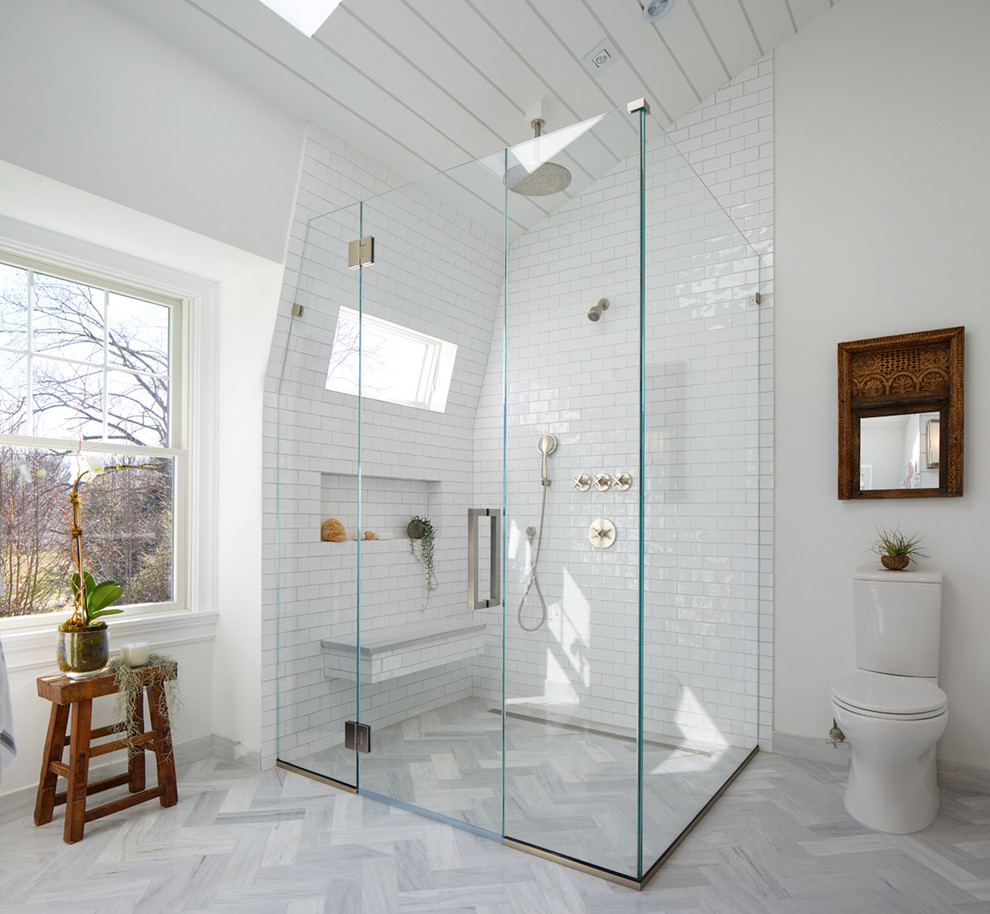 Photo of a large transitional master bathroom in New York with a corner shower, a two-piece toilet, white tile, subway tile, white walls, grey floor, marble floors, a pedestal sink, grey cabinets and marble benchtops.