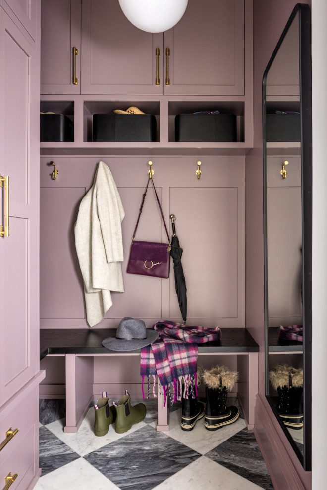 Transitional marble floor entryway photo in New York with purple walls