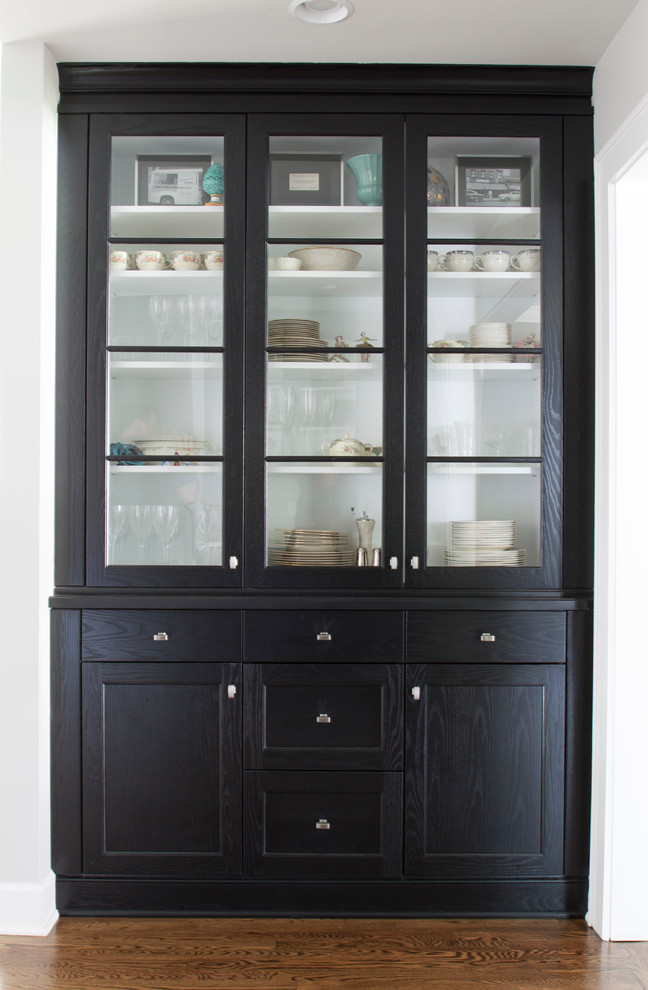 Example of a large transitional l-shaped dark wood floor enclosed kitchen design in Newark with a farmhouse sink, shaker cabinets, white cabinets, marble countertops, white backsplash, stainless steel appliances and an island