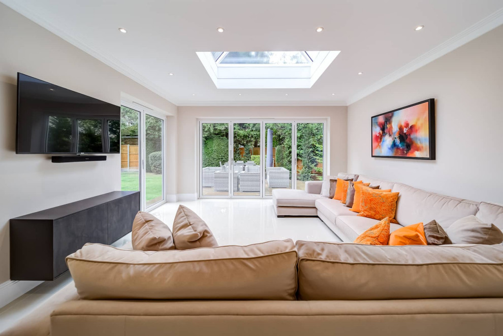 Design ideas for a large modern galley open plan kitchen in London with a built-in sink, flat-panel cabinets, dark wood cabinets, black appliances, porcelain flooring, multiple islands, white floors and black worktops.