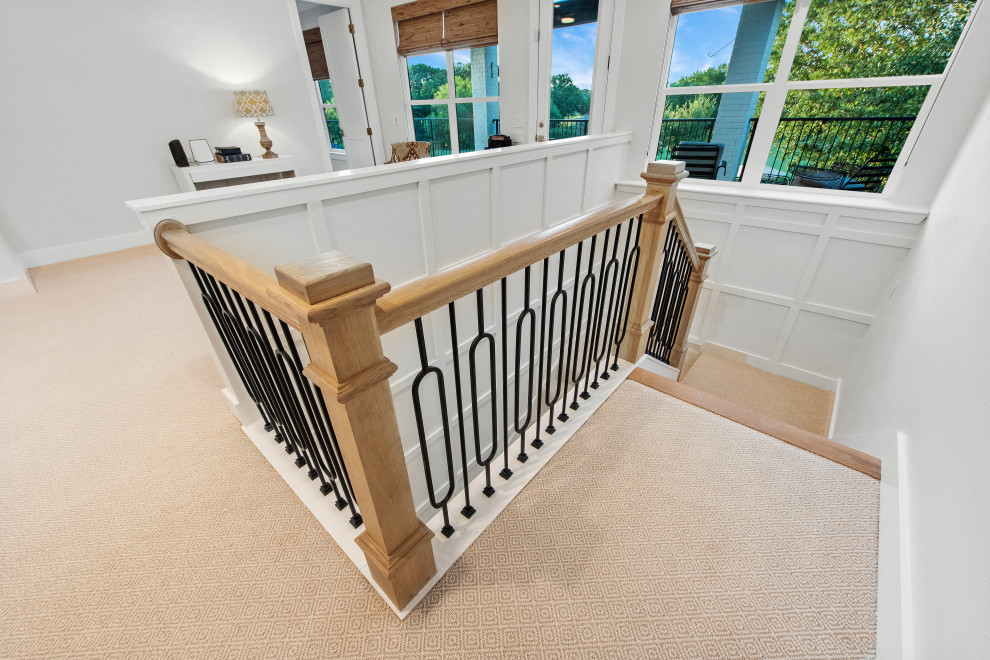Inspiration for a large transitional carpeted u-shaped metal railing and wall paneling staircase remodel with carpeted risers