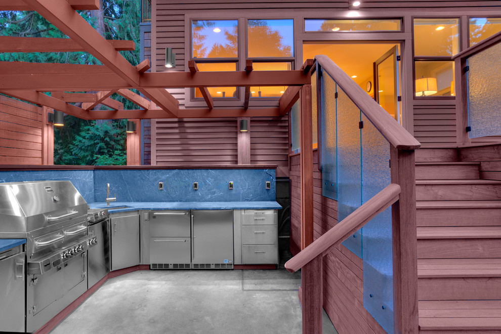 Contemporary backyard patio in Chicago with an outdoor kitchen and a pergola.