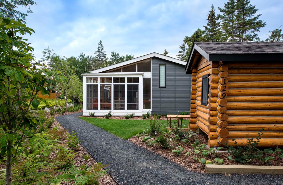 Example of a mid-sized mountain style brown one-story mixed siding gable roof design with a shingle roof