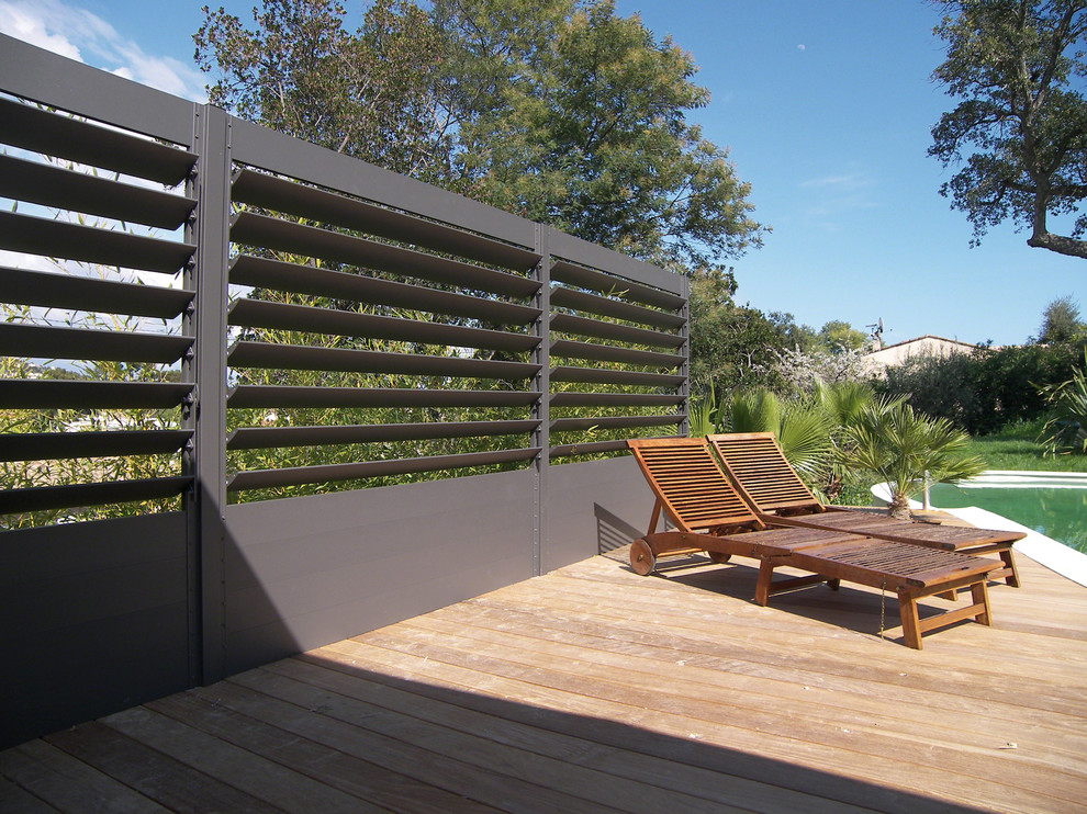This is an example of an expansive contemporary backyard deck in Berlin with no cover.