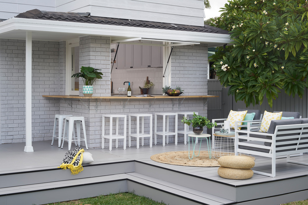This is an example of a mid-sized modern backyard deck in Sydney with no cover.