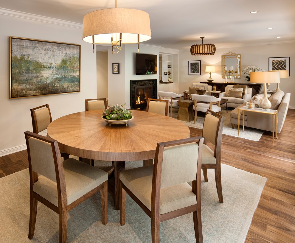 This is an example of a large transitional open plan dining in Los Angeles with beige walls, medium hardwood floors, no fireplace and brown floor.