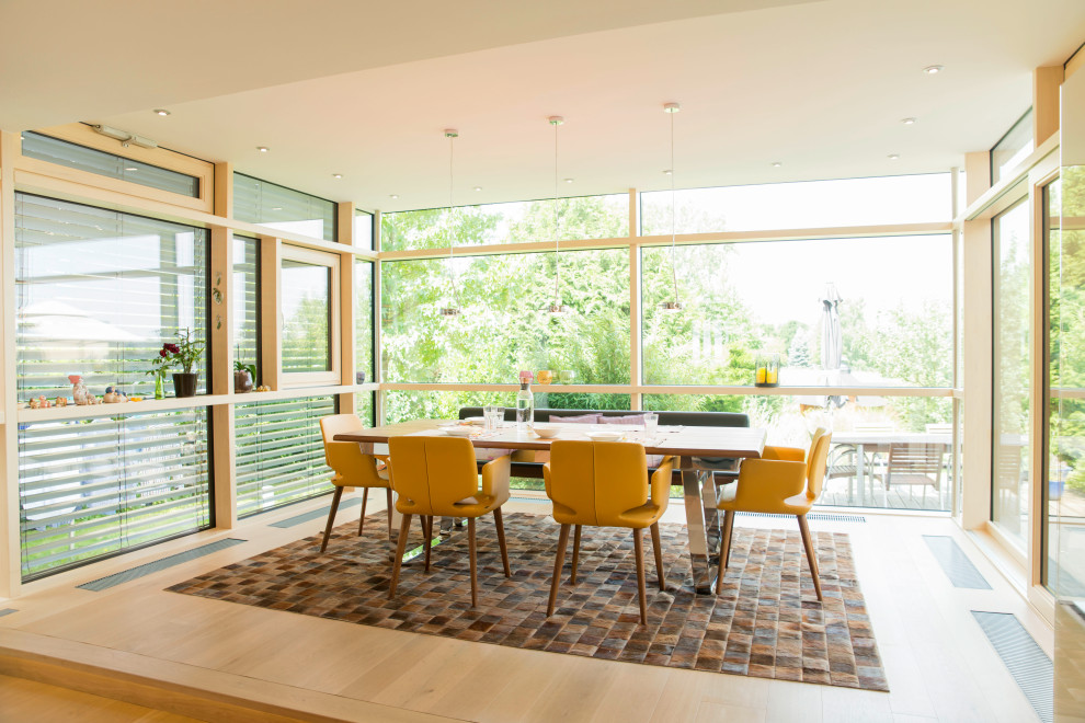 Inspiration for a large contemporary dining room in Other with light hardwood floors.