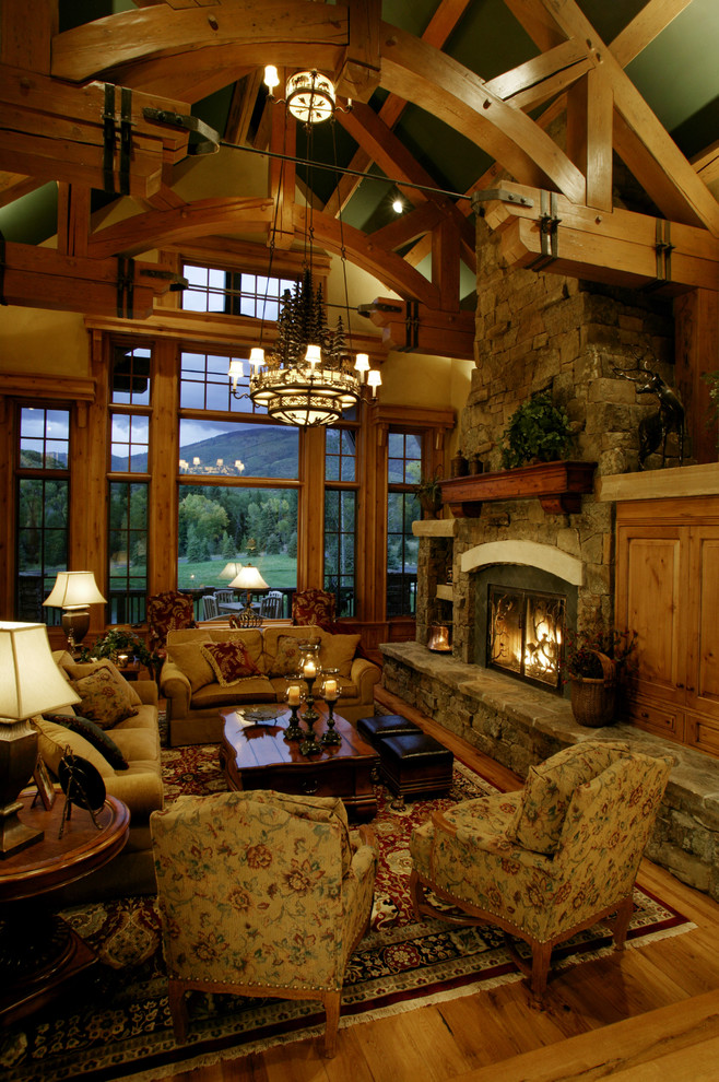 Country living room in Denver with medium hardwood floors, a standard fireplace and no tv.