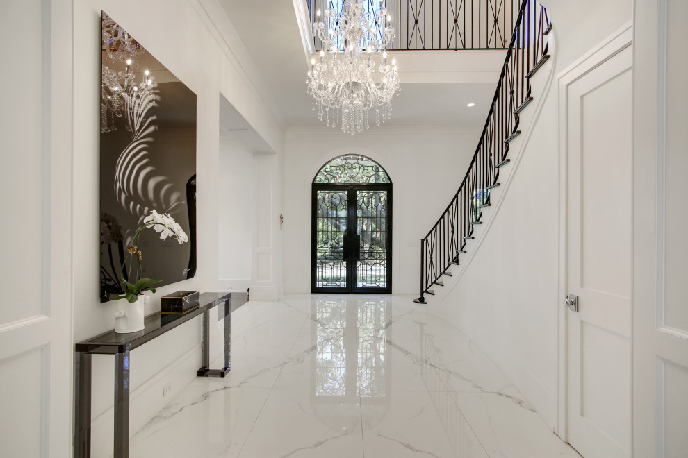 Inspiration for a large transitional foyer in New Orleans with white walls, marble floors, a double front door, a black front door, white floor and vaulted.