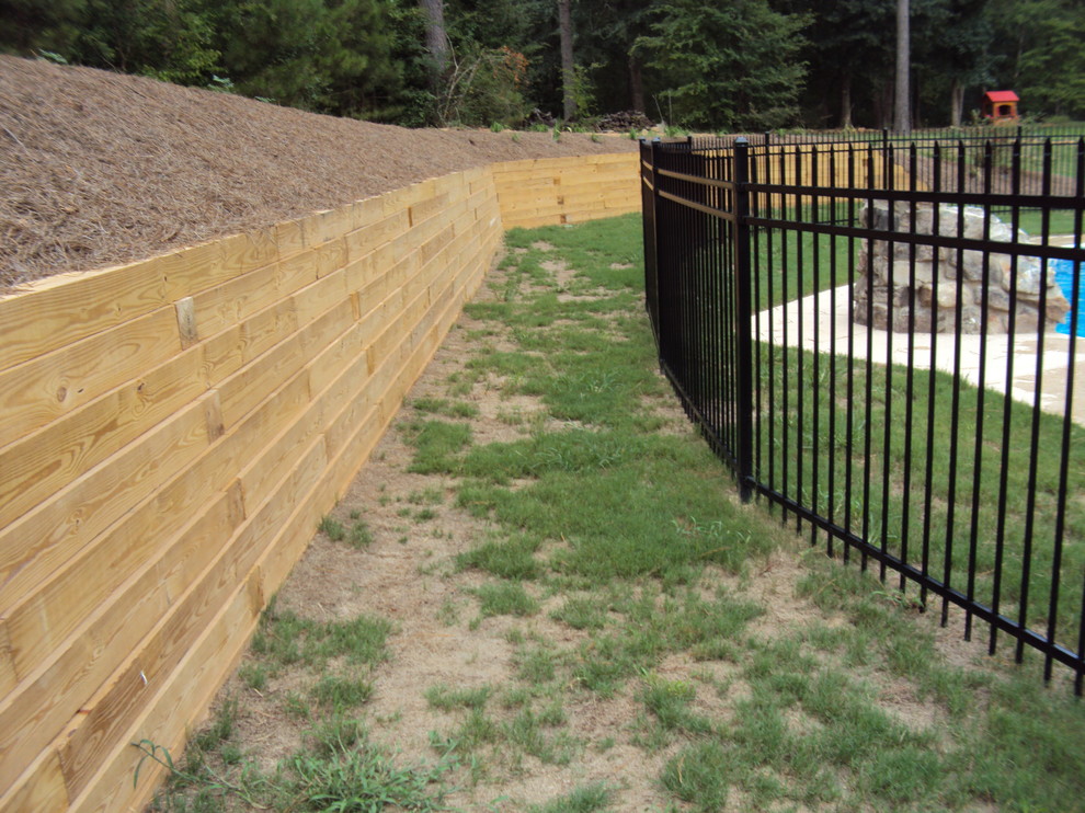 Photo of a large traditional backyard garden in Atlanta with a retaining wall.
