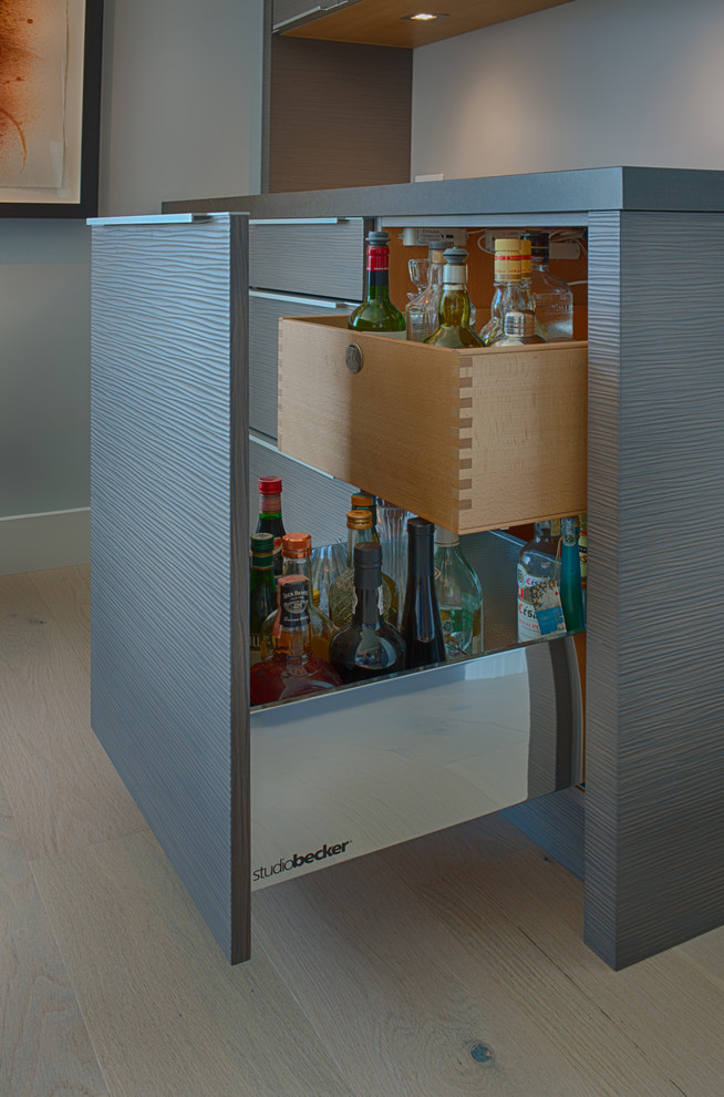 This is an example of a small contemporary single-wall wet bar in San Francisco with flat-panel cabinets and grey cabinets.