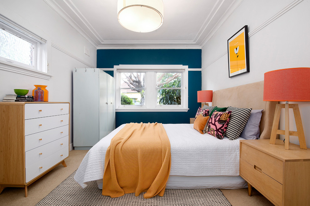 This is an example of a contemporary master bedroom in Sydney with carpet, no fireplace, beige floor and blue walls.