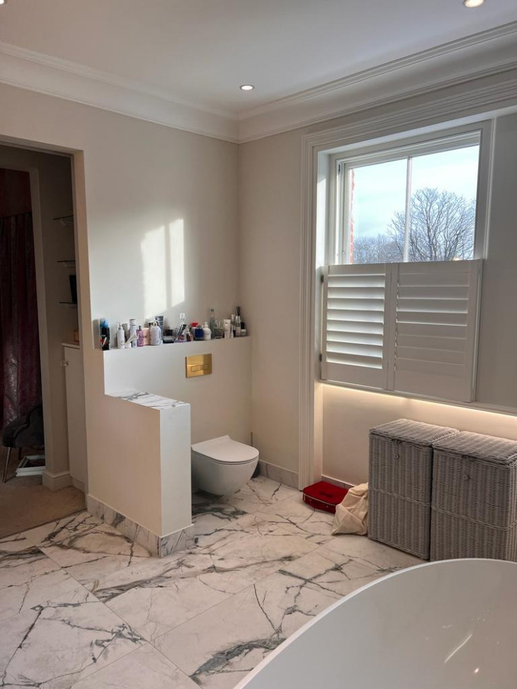 Photo of a mid-sized contemporary kids bathroom in London with open cabinets, white cabinets, a drop-in tub, a shower/bathtub combo, a one-piece toilet, white tile, cement tile, white walls, ceramic floors, a drop-in sink, copper benchtops, multi-coloured floor, a hinged shower door, brown benchtops, a double vanity, a built-in vanity, wood and wood walls.
