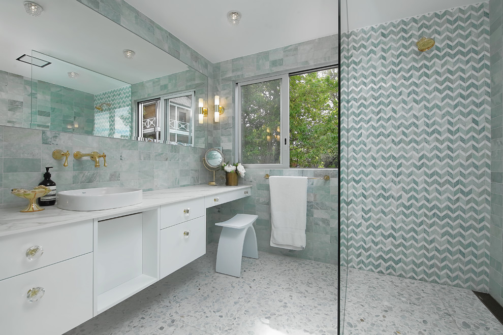 Inspiration for a contemporary master bathroom in Sydney with flat-panel cabinets, white cabinets, a curbless shower, blue tile, white tile, a vessel sink, multi-coloured floor, an open shower and white benchtops.