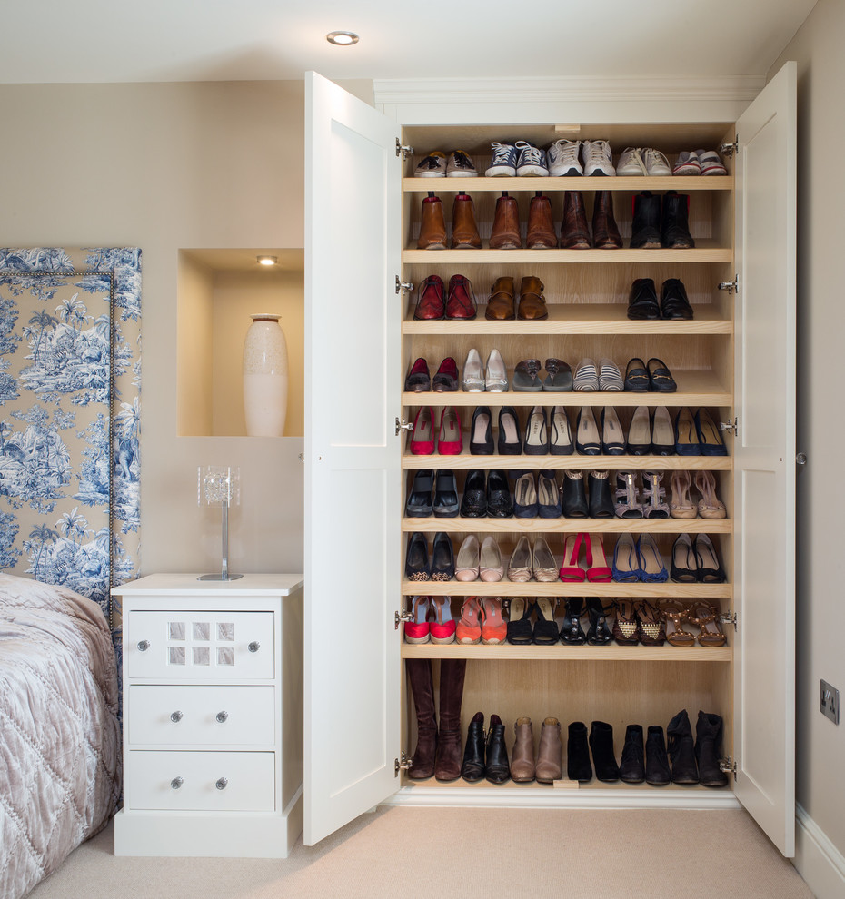 Inspiration for a transitional gender-neutral storage and wardrobe in Other with shaker cabinets, white cabinets, carpet and beige floor.