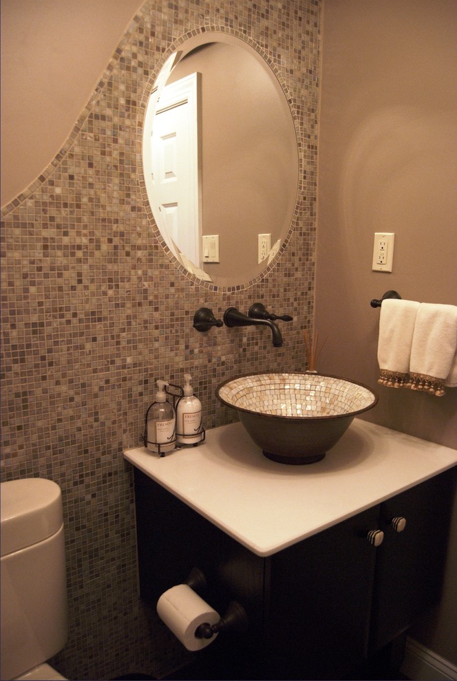 Transitional powder room in Philadelphia with a vessel sink, gray tile, mosaic tile, dark wood cabinets and grey walls.