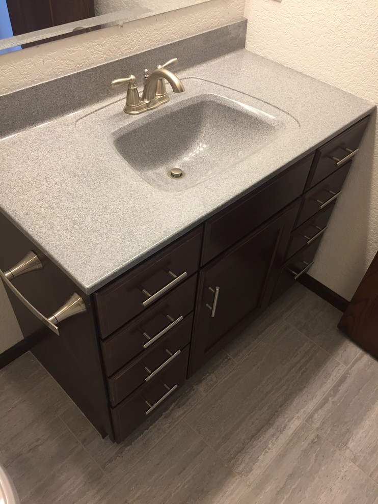 Mid-sized traditional kids bathroom in Other with recessed-panel cabinets, dark wood cabinets, white walls, ceramic floors, onyx benchtops and grey floor.