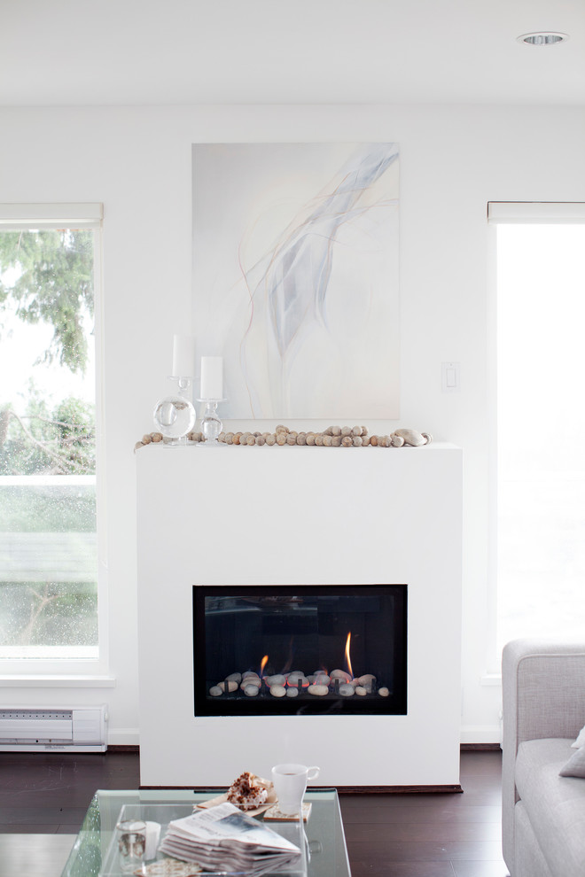 Design ideas for a small transitional open concept living room in Vancouver with white walls, dark hardwood floors, a standard fireplace and a plaster fireplace surround.