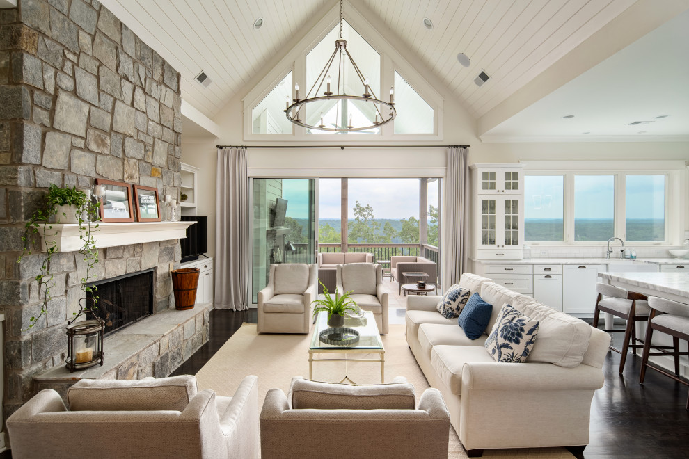 Inspiration for a mid-sized timeless open concept dark wood floor, brown floor and vaulted ceiling living room remodel in Atlanta with white walls, a standard fireplace and a stone fireplace