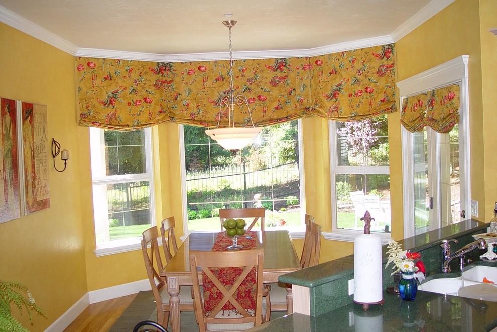 Example of a mid-sized southwest medium tone wood floor and brown floor eat-in kitchen design with a double-bowl sink and granite countertops