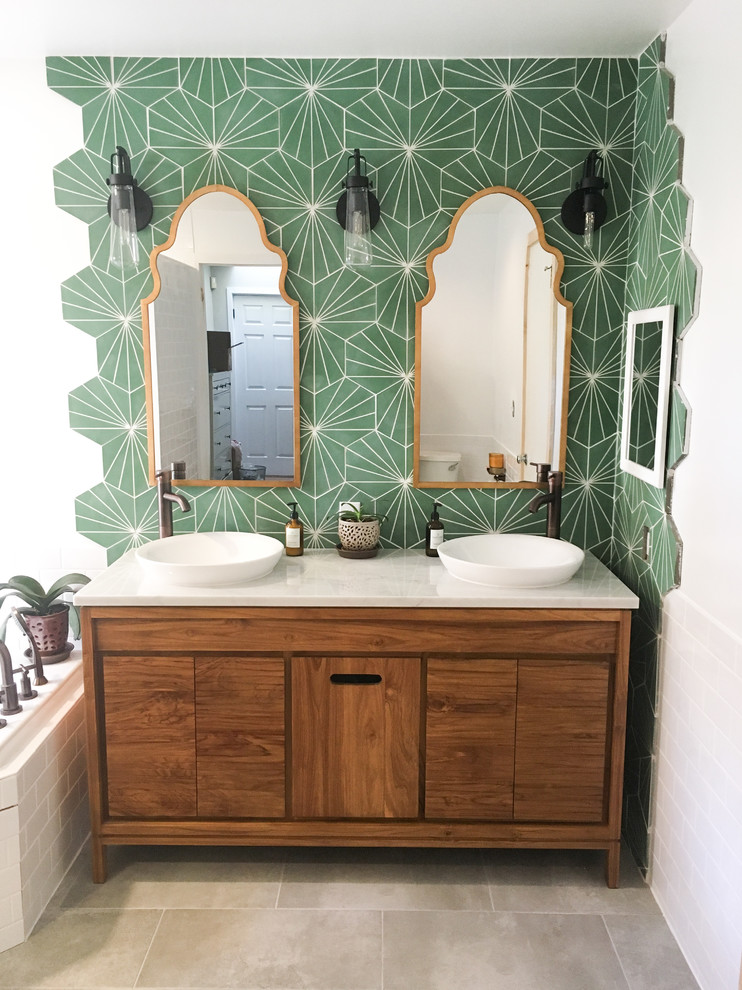 Example of a mid-sized eclectic master green tile porcelain tile and gray floor bathroom design in Philadelphia with furniture-like cabinets, medium tone wood cabinets, white walls, a vessel sink, quartzite countertops and white countertops