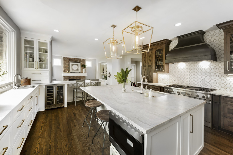 Kitchen - large transitional dark wood floor and brown floor kitchen idea in Denver with an undermount sink, raised-panel cabinets, dark wood cabinets, quartzite countertops, gray backsplash, marble backsplash, stainless steel appliances, an island and white countertops