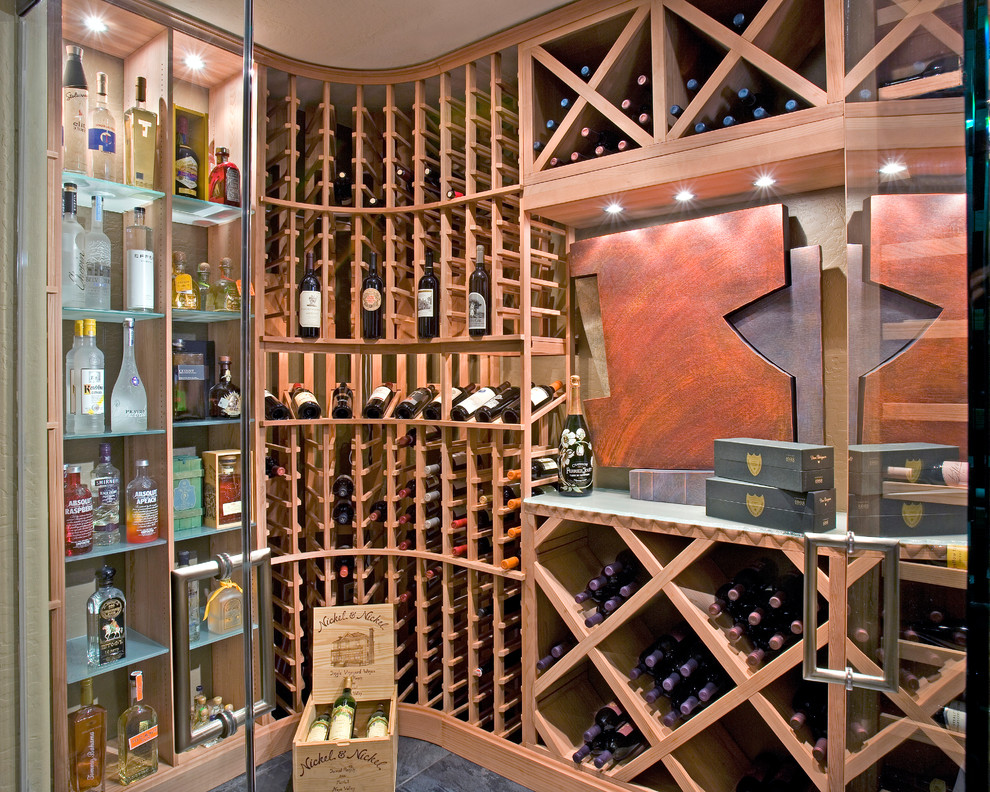 Inspiration for a mid-sized transitional wine cellar in Phoenix with porcelain floors, storage racks and black floor.