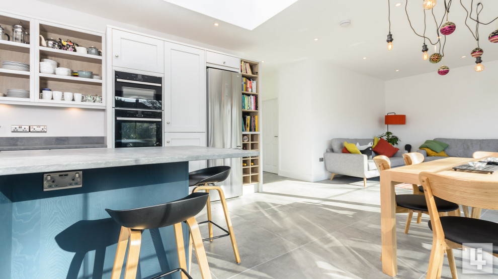 This is an example of a large contemporary eat-in kitchen in Other with an undermount sink, shaker cabinets, blue cabinets, quartzite benchtops, grey splashback, with island, grey floor and grey benchtop.