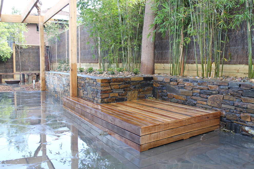 Design ideas for a mid-sized traditional backyard shaded outdoor sport court in Melbourne with natural stone pavers.